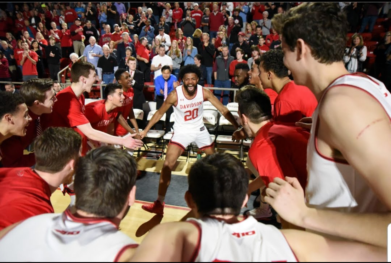 KiShawn Pritchett surrounded by Davidson teammates before a game